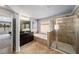 Bathroom with dark vanity, tub, and glass enclosed shower at 1520 Gallant Fox Ln, Suwanee, GA 30024
