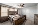 Comfortable bedroom with warm wood furniture, neutral carpet, and plenty of natural light at 1520 Gallant Fox Ln, Suwanee, GA 30024