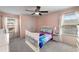 Bright bedroom with pink walls, large windows, and a bed at 1520 Gallant Fox Ln, Suwanee, GA 30024