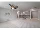 Large bonus room with neutral carpeting and a staircase with dark metal spindles at 1520 Gallant Fox Ln, Suwanee, GA 30024