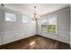 Bright dining room with decorative trim, hardwood floors, and large window views at 1520 Gallant Fox Ln, Suwanee, GA 30024