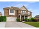 Attractive two-story brick home featuring a two-car garage and a well-maintained lawn at 1520 Gallant Fox Ln, Suwanee, GA 30024