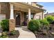Inviting covered porch with stylish columns and manicured landscaping at 1520 Gallant Fox Ln, Suwanee, GA 30024