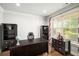 Bright home office with a large desk and ample storage space at 1520 Gallant Fox Ln, Suwanee, GA 30024