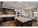Open-concept kitchen with stainless steel appliances, granite island and views of the living area at 1520 Gallant Fox Ln, Suwanee, GA 30024