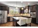 Modern kitchen with stainless steel appliances, granite countertops, and a center island with bar stools at 1520 Gallant Fox Ln, Suwanee, GA 30024