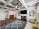 Bright living room with coffered ceiling, fireplace, built-in shelves, and hardwood floors at 1520 Gallant Fox Ln, Suwanee, GA 30024