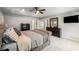 Main bedroom features a trey ceiling, ceiling fan, carpet flooring, and a television at 1520 Gallant Fox Ln, Suwanee, GA 30024