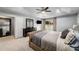 Main bedroom features a trey ceiling, ceiling fan, carpet flooring, and dresser at 1520 Gallant Fox Ln, Suwanee, GA 30024