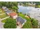 Scenic aerial view of a home with lake access, lush greenery, and a serene neighborhood at 2045 Calmwater Ct, Suwanee, GA 30024