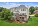 Home's backyard showcases a two-story deck with a porch swing and green lawn at 2045 Calmwater Ct, Suwanee, GA 30024