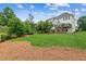 Expansive backyard featuring a lush lawn and a charming two-story deck at 2045 Calmwater Ct, Suwanee, GA 30024