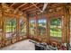 Unfinished basement area with multiple windows overlooking the backyard and lake view, offering potential living space at 2045 Calmwater Ct, Suwanee, GA 30024