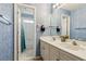 Well-lit bathroom features dual vanity sinks and a combined shower and tub at 2045 Calmwater Ct, Suwanee, GA 30024