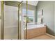 Bathroom with a soaking tub, separate shower, and a window overlooking a lake at 2045 Calmwater Ct, Suwanee, GA 30024