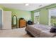 Serene bedroom features neutral paint, plush carpet, and dual windows overlooking nature at 2045 Calmwater Ct, Suwanee, GA 30024