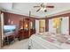 Spacious bedroom with tray ceilings, four-poster bed, dresser, and adjoining bathroom at 2045 Calmwater Ct, Suwanee, GA 30024