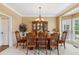Refined dining room with a decorative chandelier, wainscoting, and ample natural light from bay window at 2045 Calmwater Ct, Suwanee, GA 30024