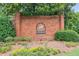 Community entrance with lush landscaping and a classic brick sign at 2045 Calmwater Ct, Suwanee, GA 30024