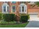 Charming front entrance featuring well-maintained landscaping and a convenient attached garage at 2045 Calmwater Ct, Suwanee, GA 30024