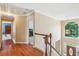 Bright hallway with wood floors, white trim, and a large arched window overlooking the front yard at 2045 Calmwater Ct, Suwanee, GA 30024