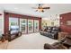 Living room with large windows and a comfortable leather couch at 2045 Calmwater Ct, Suwanee, GA 30024