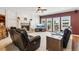Comfortable living room with a fireplace, hardwood floors, and large windows offering pleasant views at 2045 Calmwater Ct, Suwanee, GA 30024