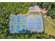 Aerial view of tennis courts with beautiful landscaping at 2045 Calmwater Ct, Suwanee, GA 30024
