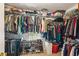 Organized walk-in closet with ample storage space for clothing, shoes, and accessories at 2045 Calmwater Ct, Suwanee, GA 30024