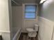 Cozy bathroom featuring a shower/tub combo, toilet, and window providing natural light at 2226 Medfield Ne Trl, Atlanta, GA 30345