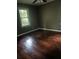 Cozy bedroom features hardwood floors and natural light from a large window at 2226 Medfield Ne Trl, Atlanta, GA 30345