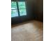 Bedroom with hardwood floors, dark paneling, and a large window at 2226 Medfield Ne Trl, Atlanta, GA 30345