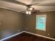 Bedroom featuring hardwood flooring, a window, and a ceiling fan with lighting at 2226 Medfield Ne Trl, Atlanta, GA 30345
