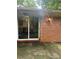 Brick exterior with sliding glass door and outdoor sconce lighting fixture at 2226 Medfield Ne Trl, Atlanta, GA 30345
