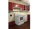 Classic kitchen with white countertops, red cabinets, and white appliances at 2226 Medfield Ne Trl, Atlanta, GA 30345