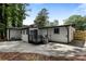 Backyard featuring concrete patio and rear exterior of white single story house at 4720 Shoshonee Trl, College Park, GA 30349