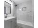 Bathroom with marble shower, bathtub, gray vanity and modern sink at 4720 Shoshonee Trl, College Park, GA 30349