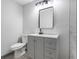 Bathroom featuring a gray vanity, modern sink and fixtures, and a toilet at 4720 Shoshonee Trl, College Park, GA 30349