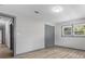 Bedroom features wood-look flooring, natural light from a window, and neutral gray walls at 4720 Shoshonee Trl, College Park, GA 30349
