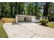 Spacious carport with a concrete floor, white brick walls, and a rear door for convenience at 4720 Shoshonee Trl, College Park, GA 30349
