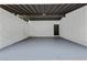 Under the carport showing a large concrete floor and a rear door for convenience at 4720 Shoshonee Trl, College Park, GA 30349