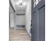 Modern entryway with coat rack bench, light fixture, and grey door at 4720 Shoshonee Trl, College Park, GA 30349