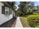 View of side yard with landscaping and walkway leading to the front entrance of the house at 4720 Shoshonee Trl, College Park, GA 30349
