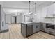 Newly renovated kitchen features an island, modern white cabinets, and stainless steel appliances at 4720 Shoshonee Trl, College Park, GA 30349
