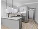 Modern kitchen with stainless steel appliances, white cabinets, and breakfast bar at 4720 Shoshonee Trl, College Park, GA 30349