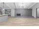 Bright living room with wood floors, gray brick fireplace, and contemporary lighting fixture at 4720 Shoshonee Trl, College Park, GA 30349