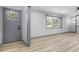 Bright living room features a stylish door, bay window, and modern flooring at 4720 Shoshonee Trl, College Park, GA 30349