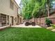 Expansive backyard showcasing a manicured lawn, patio seating, and access to a swimming pool at 9195 Tuckerbrook Ln, Alpharetta, GA 30022