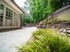 Lush backyard featuring manicured landscaping and a stone-lined walkway leading to a seating area at 9195 Tuckerbrook Ln, Alpharetta, GA 30022