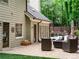 Inviting backyard patio with stylish furniture, a glimpse of a pool, and lush green landscaping at 9195 Tuckerbrook Ln, Alpharetta, GA 30022
